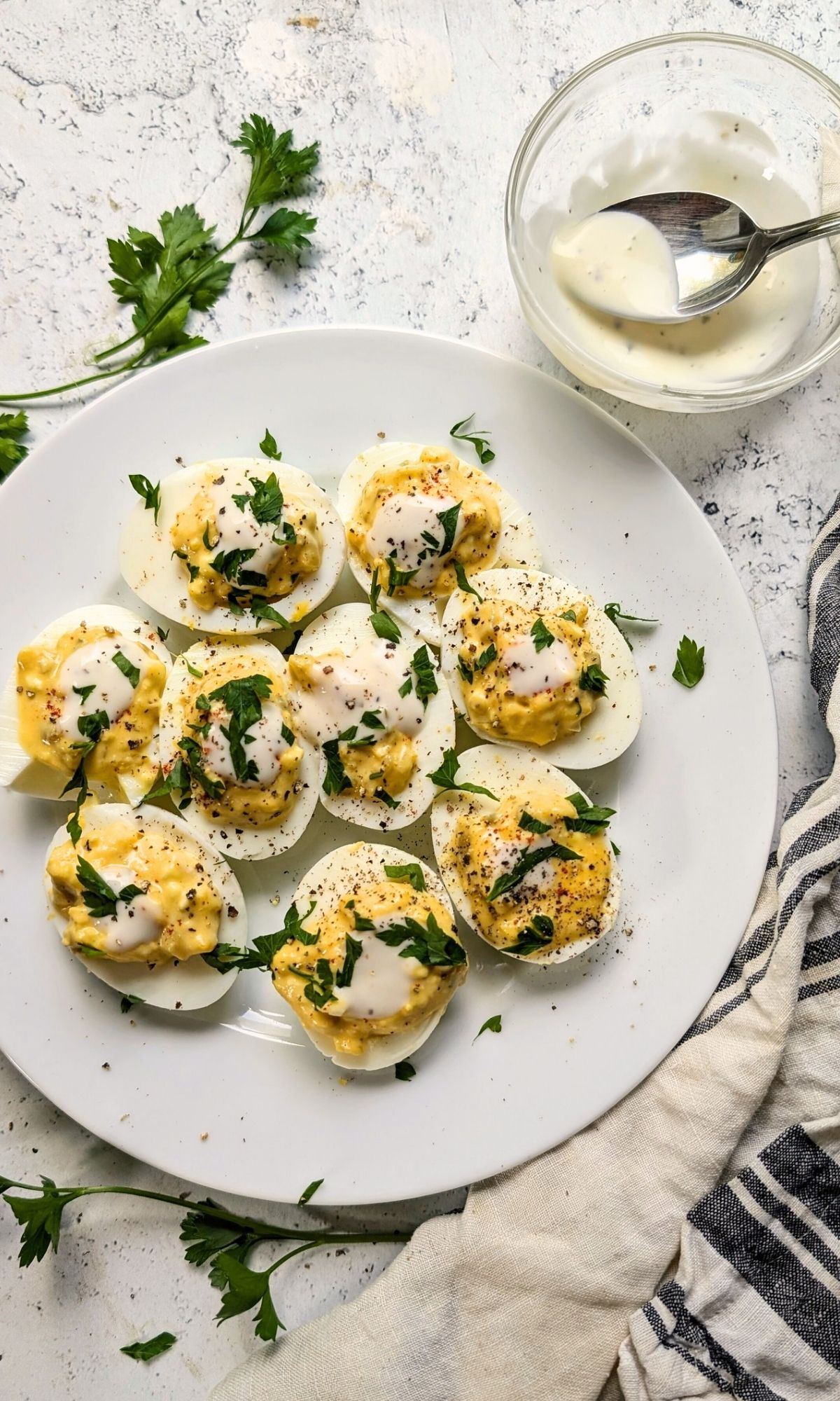 deviled eggs with ranch dressing topped with fresh chopped parsley for a mayo free appetizer.