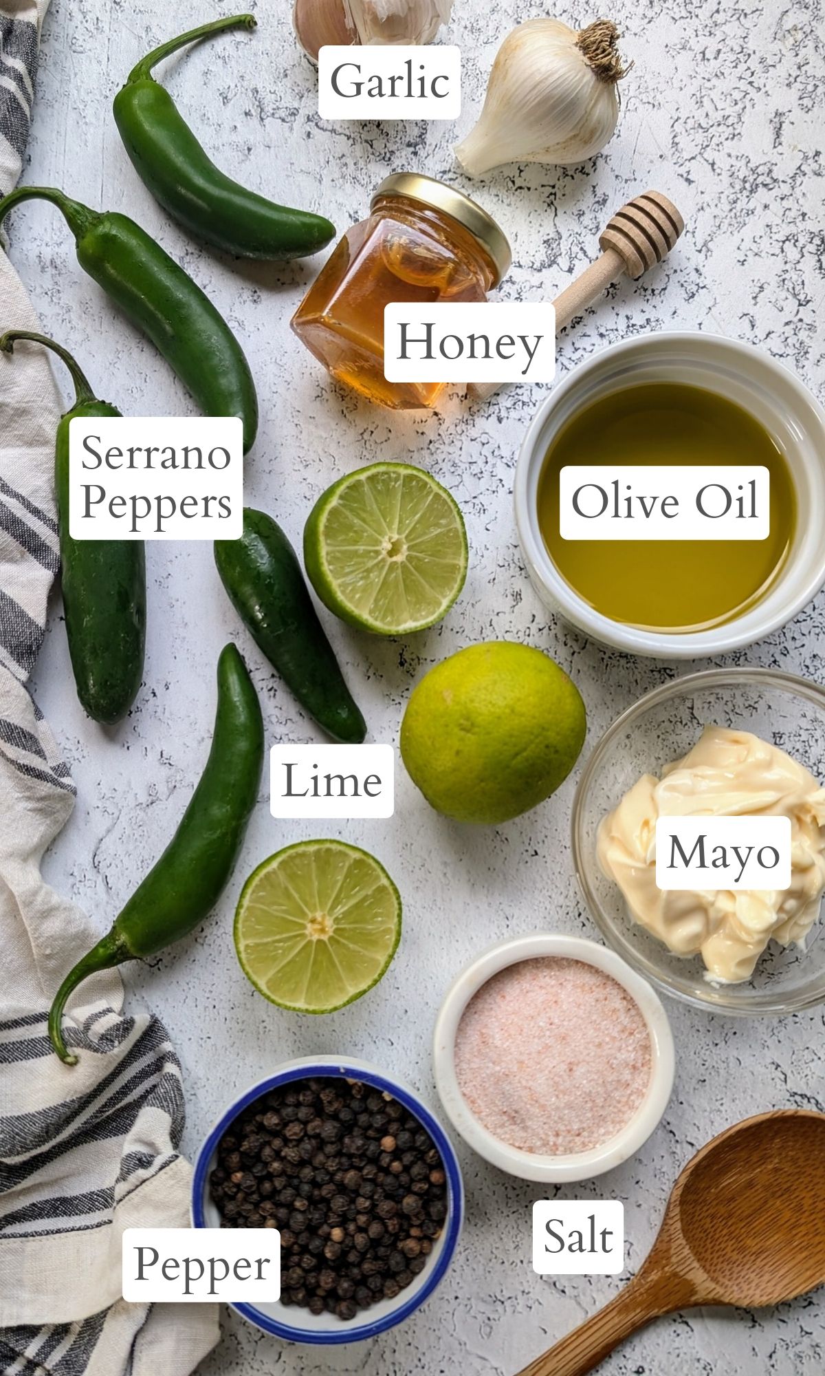 ingredients for this serrano lime dressing like serrano peppers, fresh limes, mayonnaise, olive oil, honey, salt, and pepper.