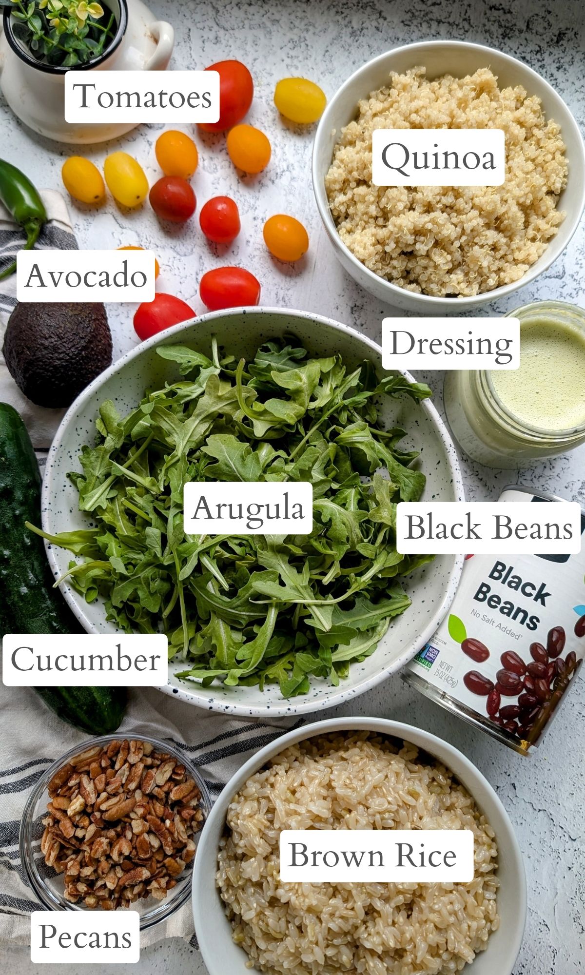 ingredients for these Southwest grain bowls like arugula, quinoa, black beans, brown rice, and creamy jalapeno pepper dressing.