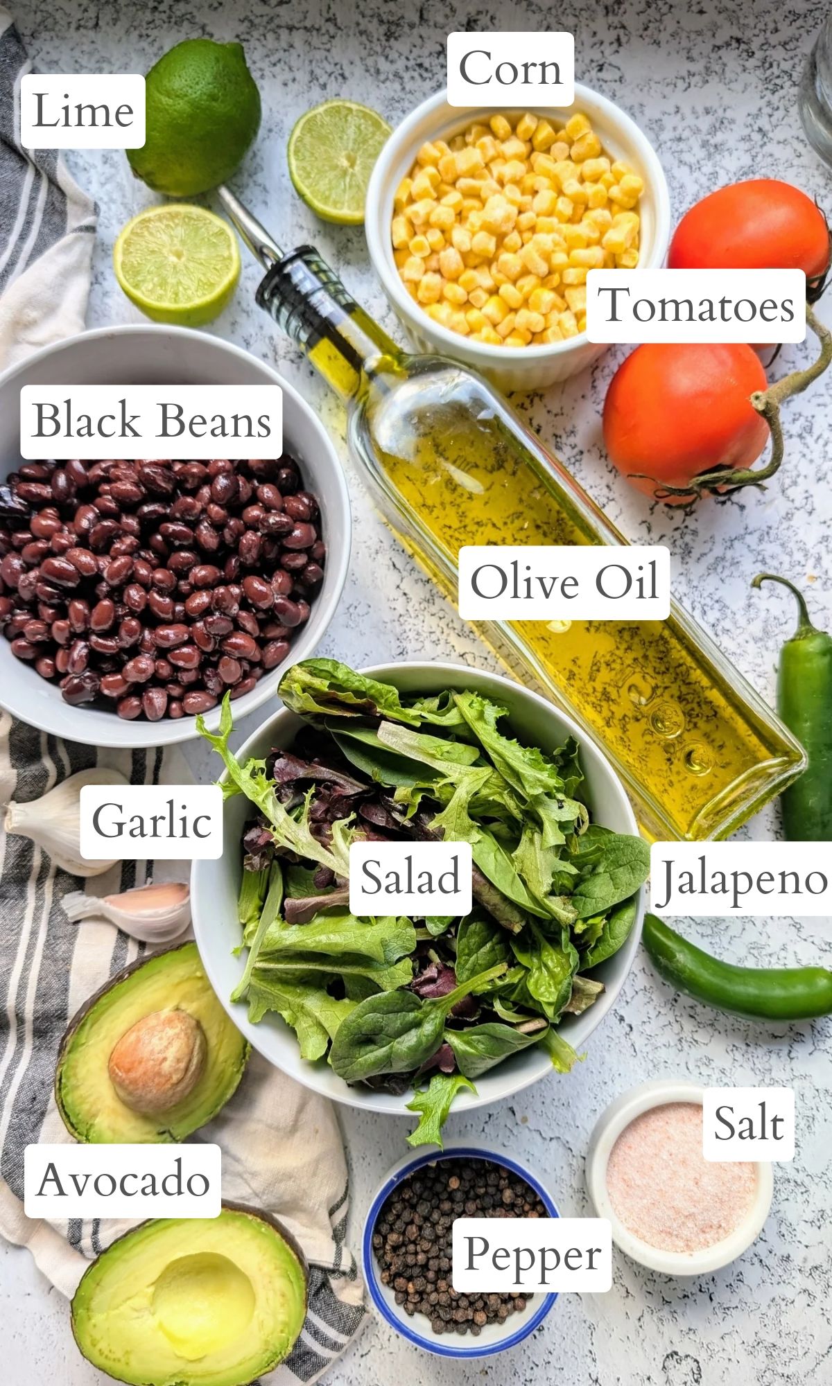 ingredients for southwest salad that is vegan and vegetarian with tomatoes, avocadoes, black beans, and fresh or frozen corn.