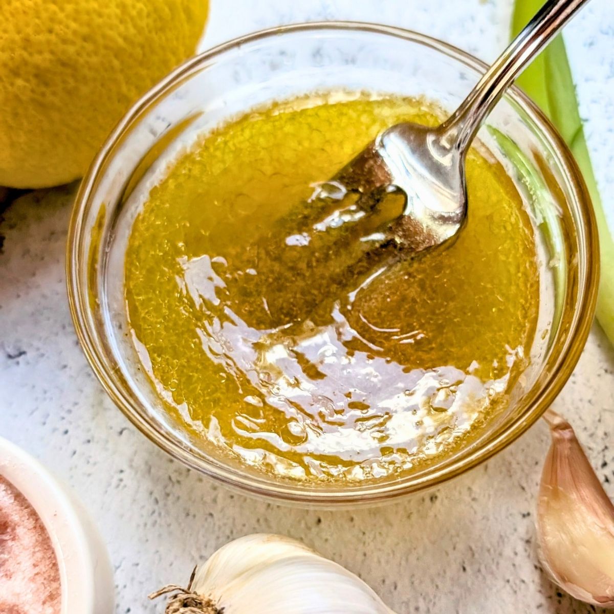 a small mixing bowl with a lemon apple cider vinaigrette dressing for bean salad with quinoa.