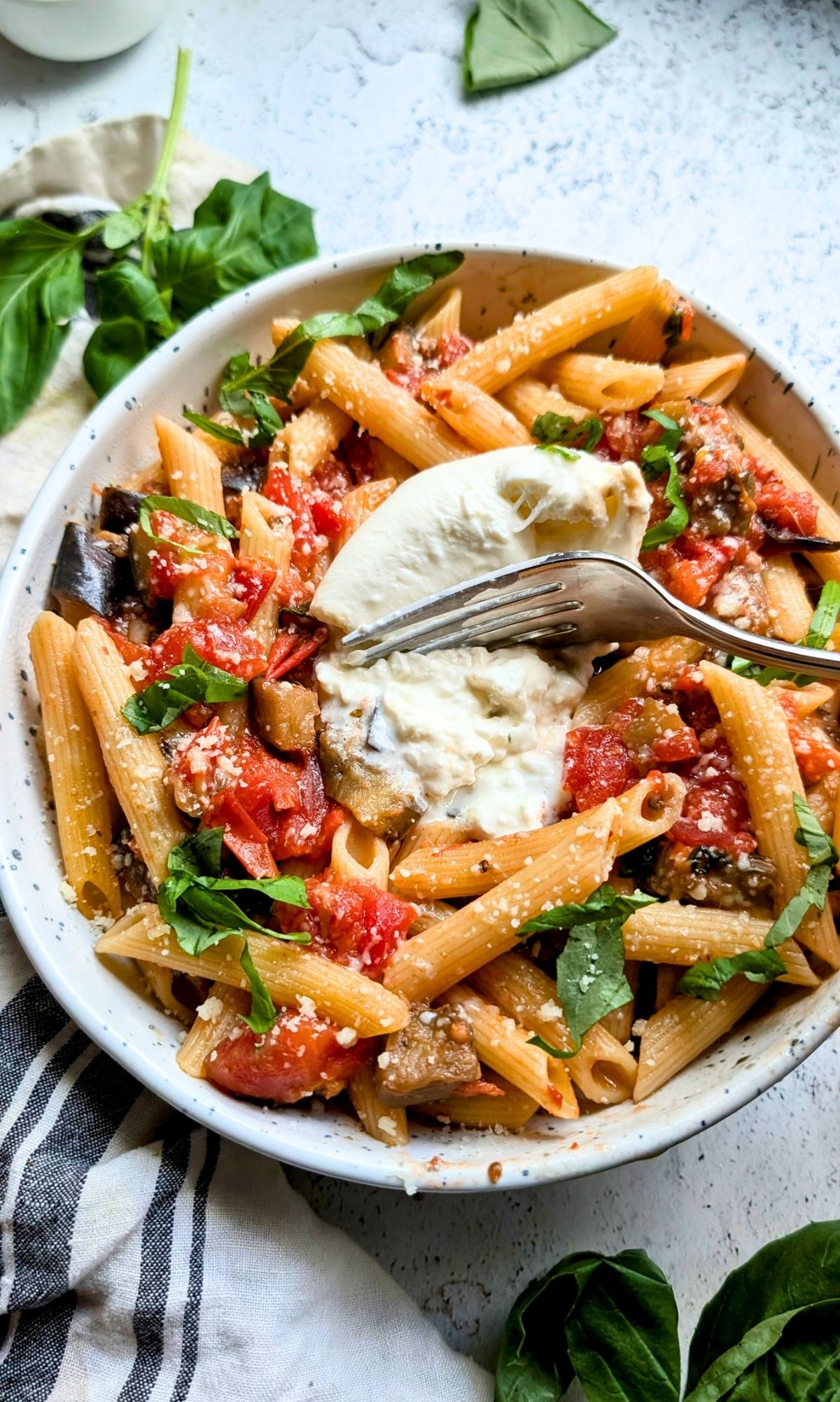 eggplant pasta with burrata sicilian penne recipe with basil, eggplant, and tomatoes.