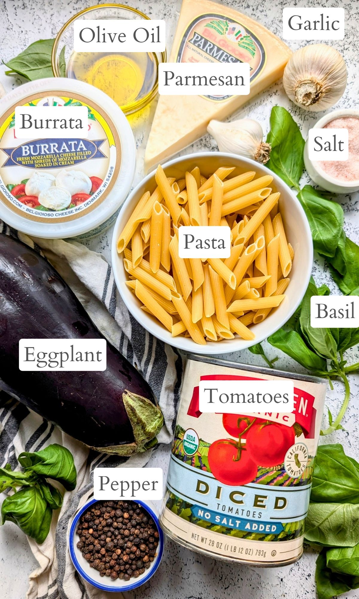 ingredients for pasta siciliana with eggplant like diced tomatoes fresh basil burrata cheese, parmesan, olive oil, and salt.