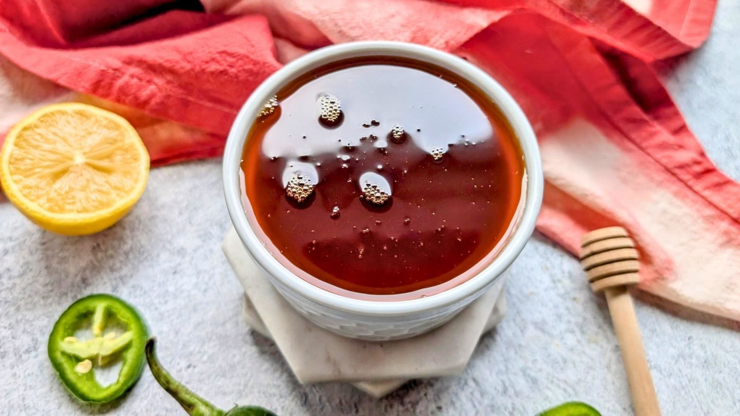 a jar of hot honey with smoky paprika and jalapeño peppers!