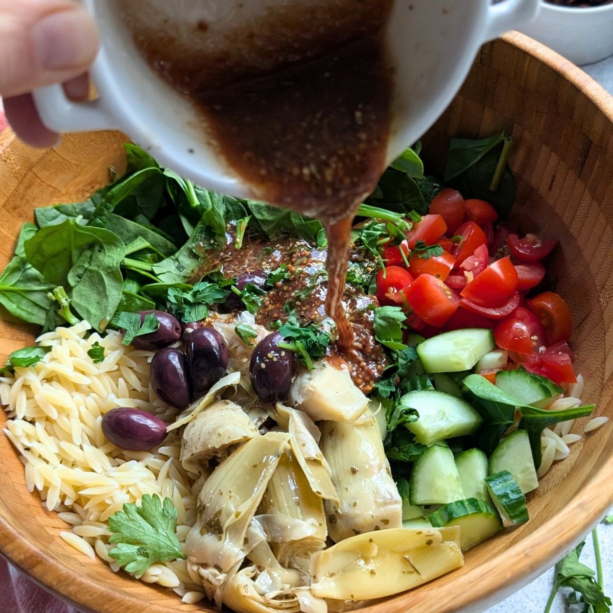 homemade vinaigrette with chopped artichoke pasta salad with orzo noodles.