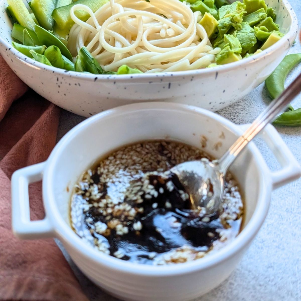 sesame lime dressing for udon salad made with toasted sesame oil, soy sauce, lime juice, and sesame seeds.