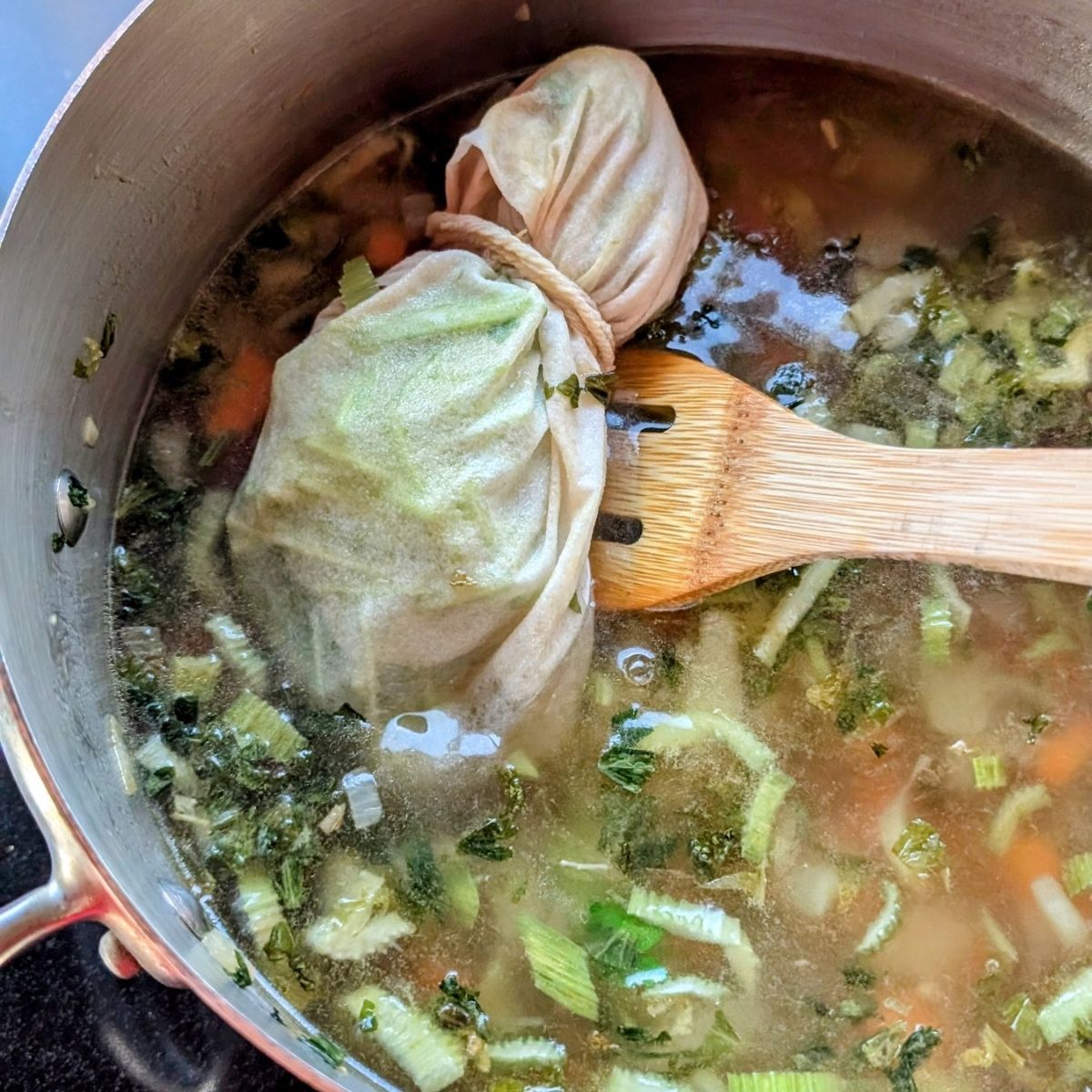 cheesecloth bag with parsley stems to make a sachet for soup with parsley