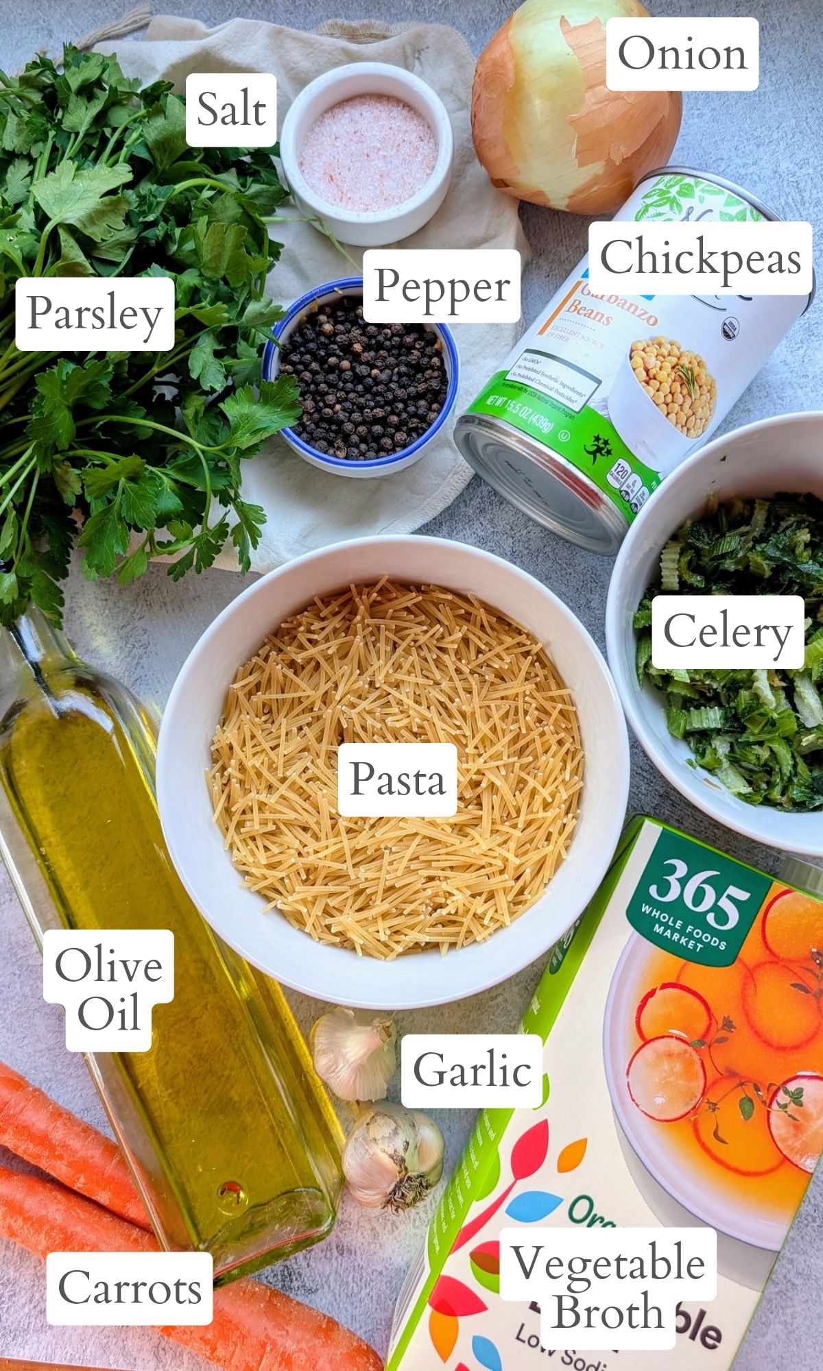 ingredients for fresh parsley soup like pasta, onions, carrots, olive oil, salt, and pepper