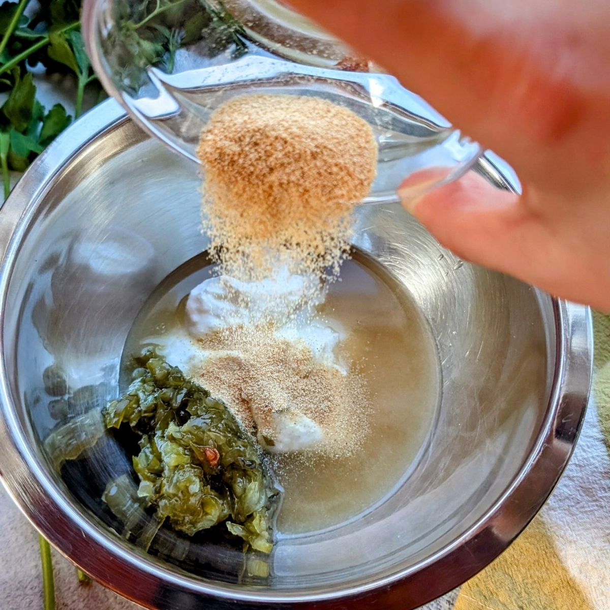 a small mixing bowl with greek yogurt, relish, apple cider vinegar, and sugar for mac salad dressing