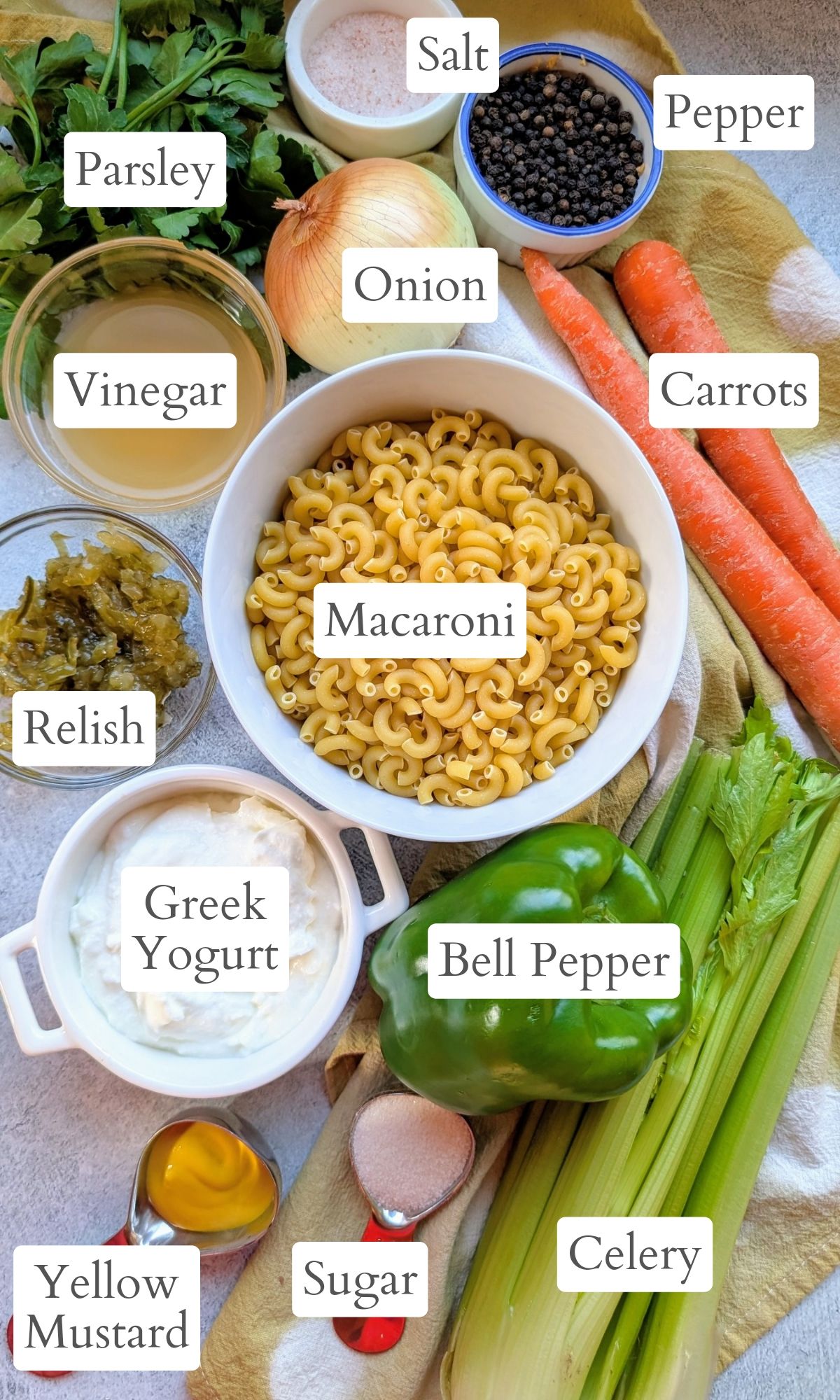 ingredients for greek yogurt pasta salad like bell pepper, onion, macaroni, relish, and carrots