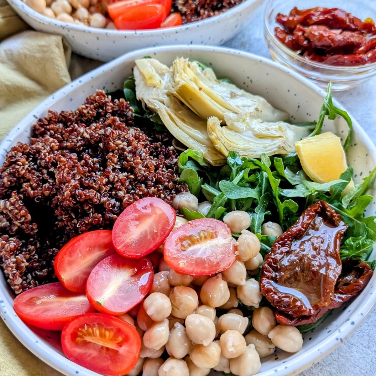 mediterranean arugula salad with red quinoa and marinated artichoke hearts