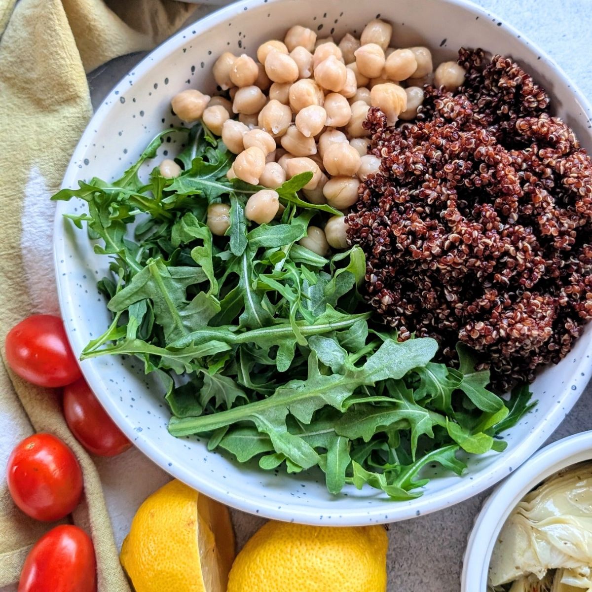 red quinoa and arugula salad with garbanzo beans for a mediterranean style hearty salad