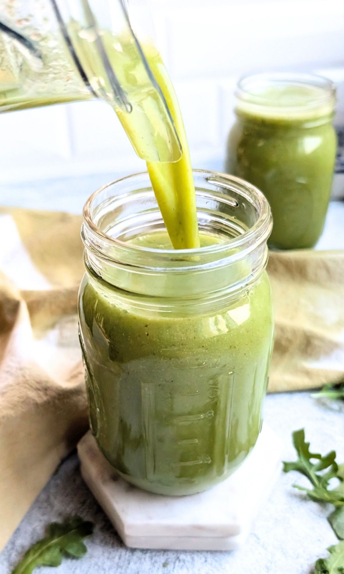 green smoothie with arugula poured into a mason jar glass for breakfast.