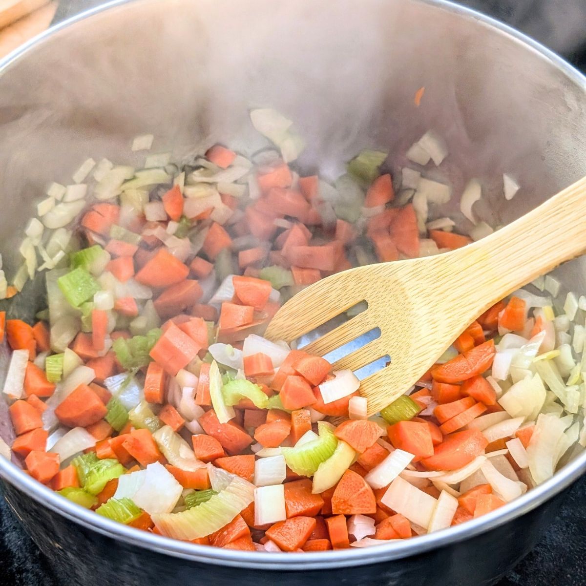 carrots, onions, and celery in a pot sauteed with olive oil to make soup