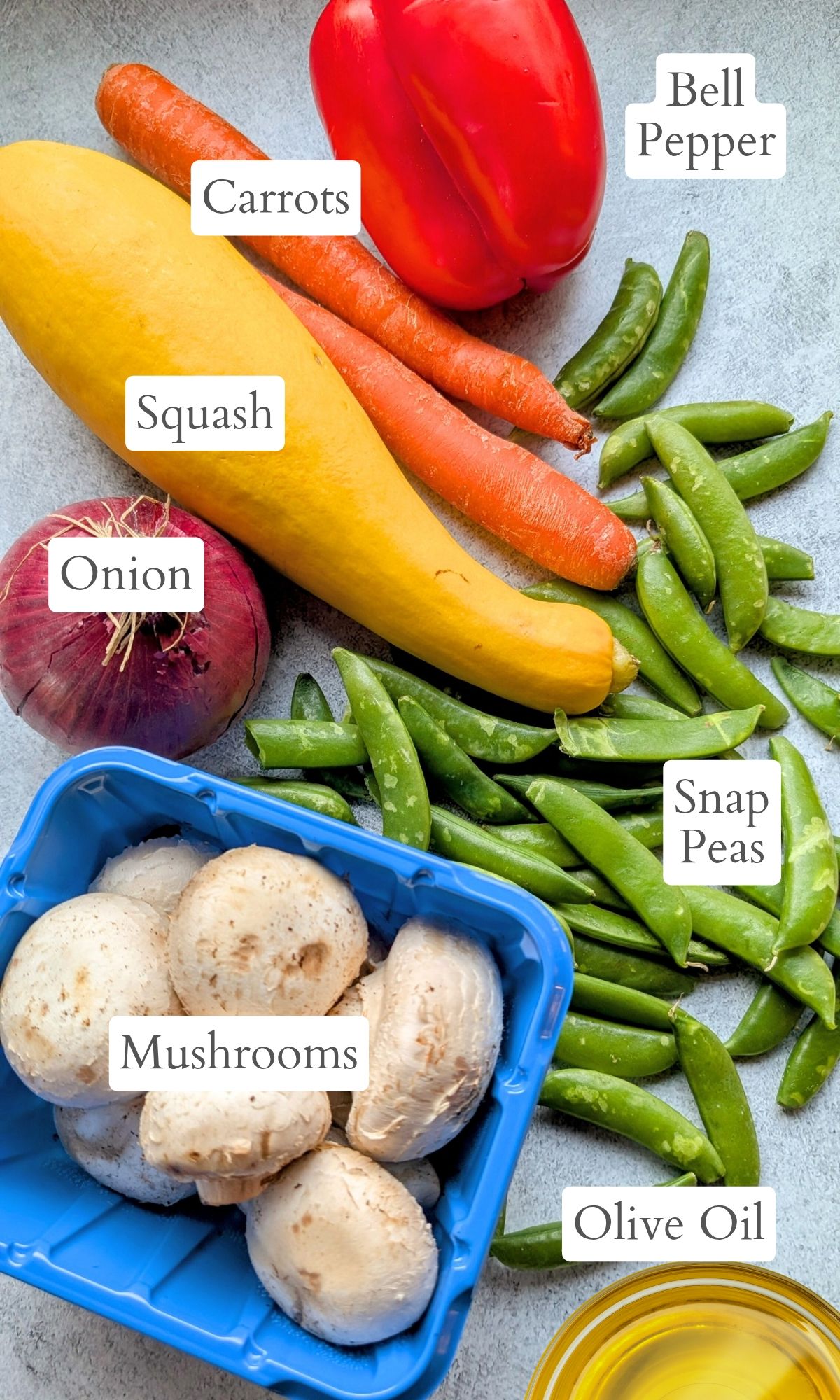 ingredients for sheet pan stir fry like mushrooms, bell pepper, onion, squash, and carrots