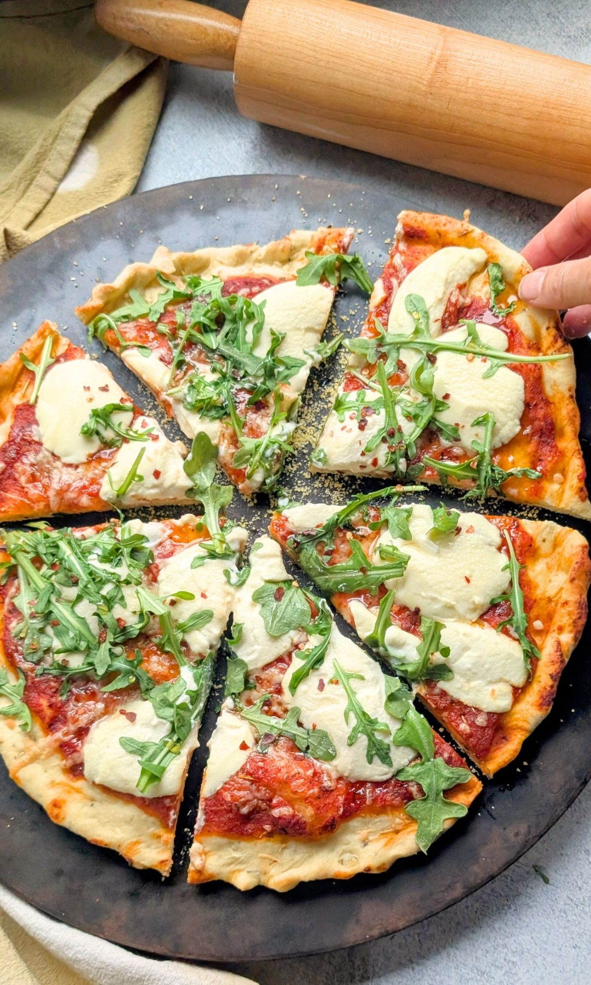 hot honey ricotta cheese pizza with arugula sliced into 6 pieces for dinner.