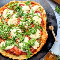 hot honey ricotta pizza recipe with arugula and tomato sauce