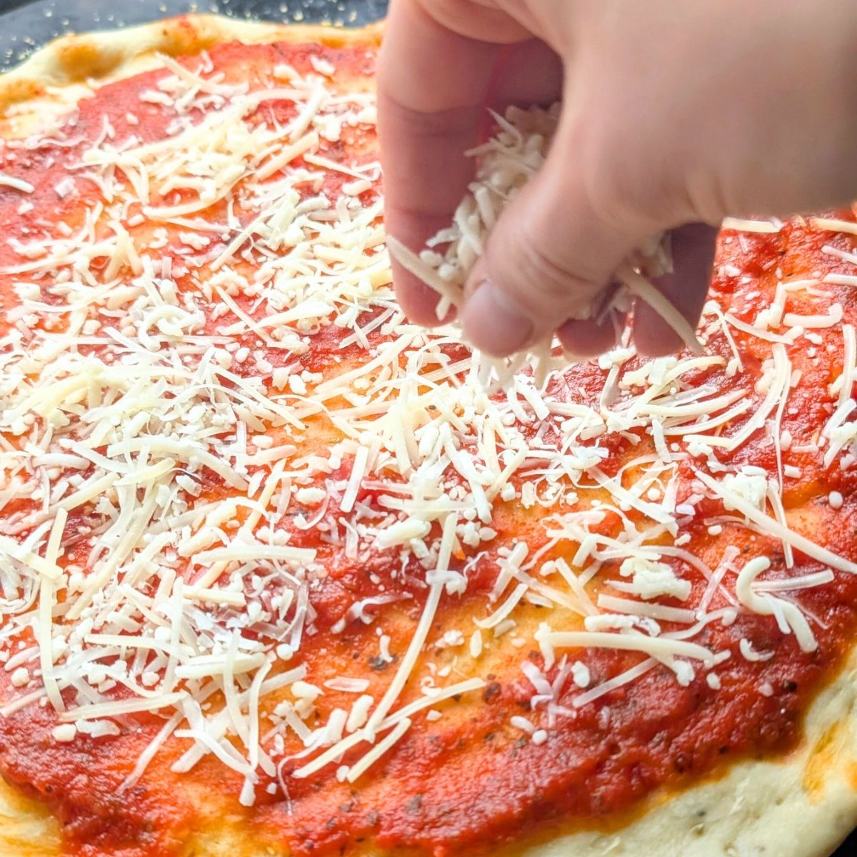 pizza baked in the oven topped with parmesan cheese