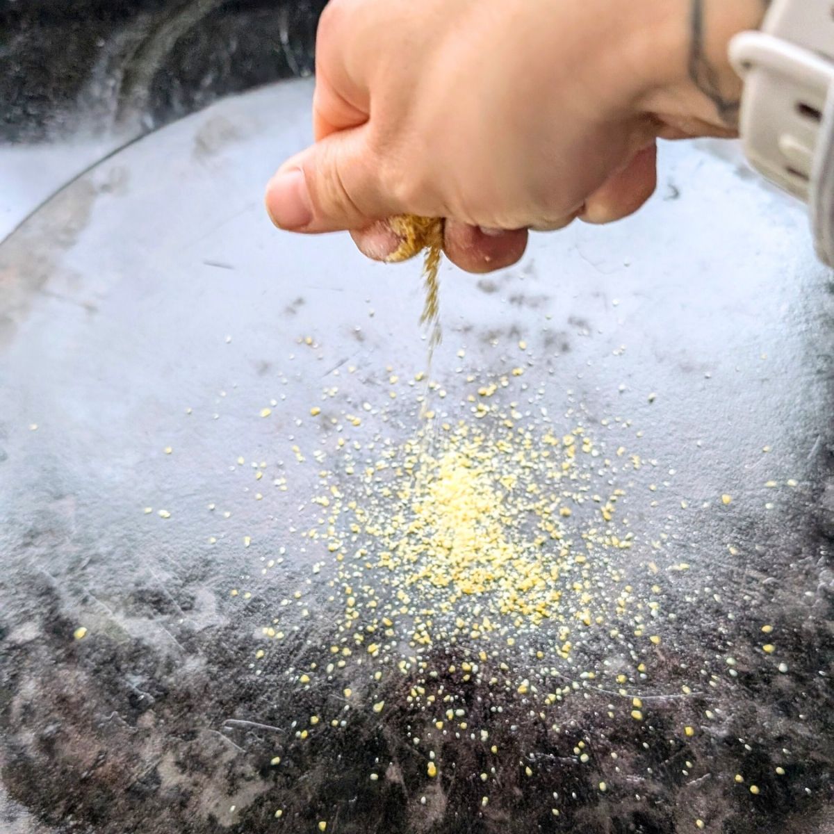 cornmeal sprinkled over a pizza stone hot out of the oven