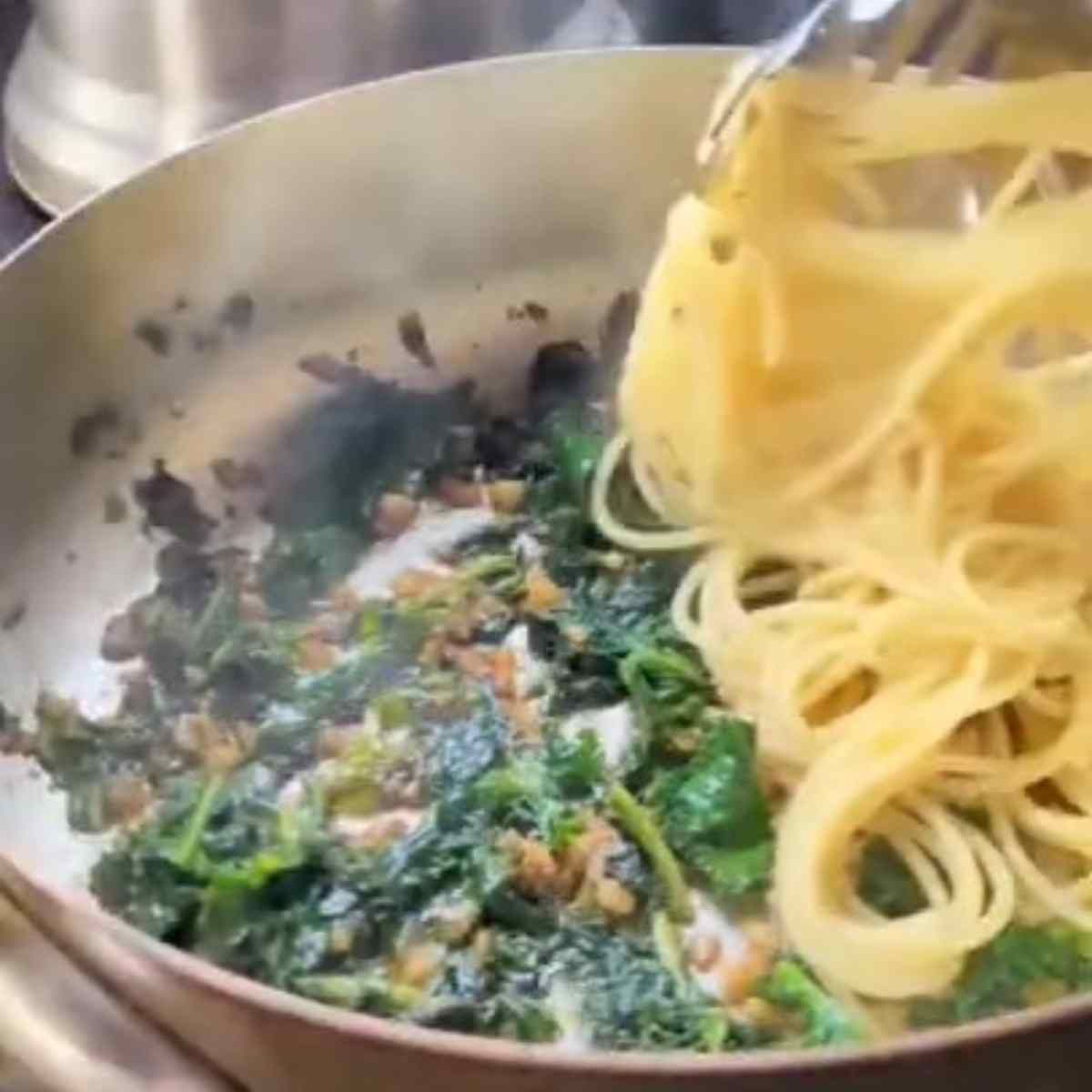 noodles tossed with kale and chili flakes and browned garlic in sesame oil