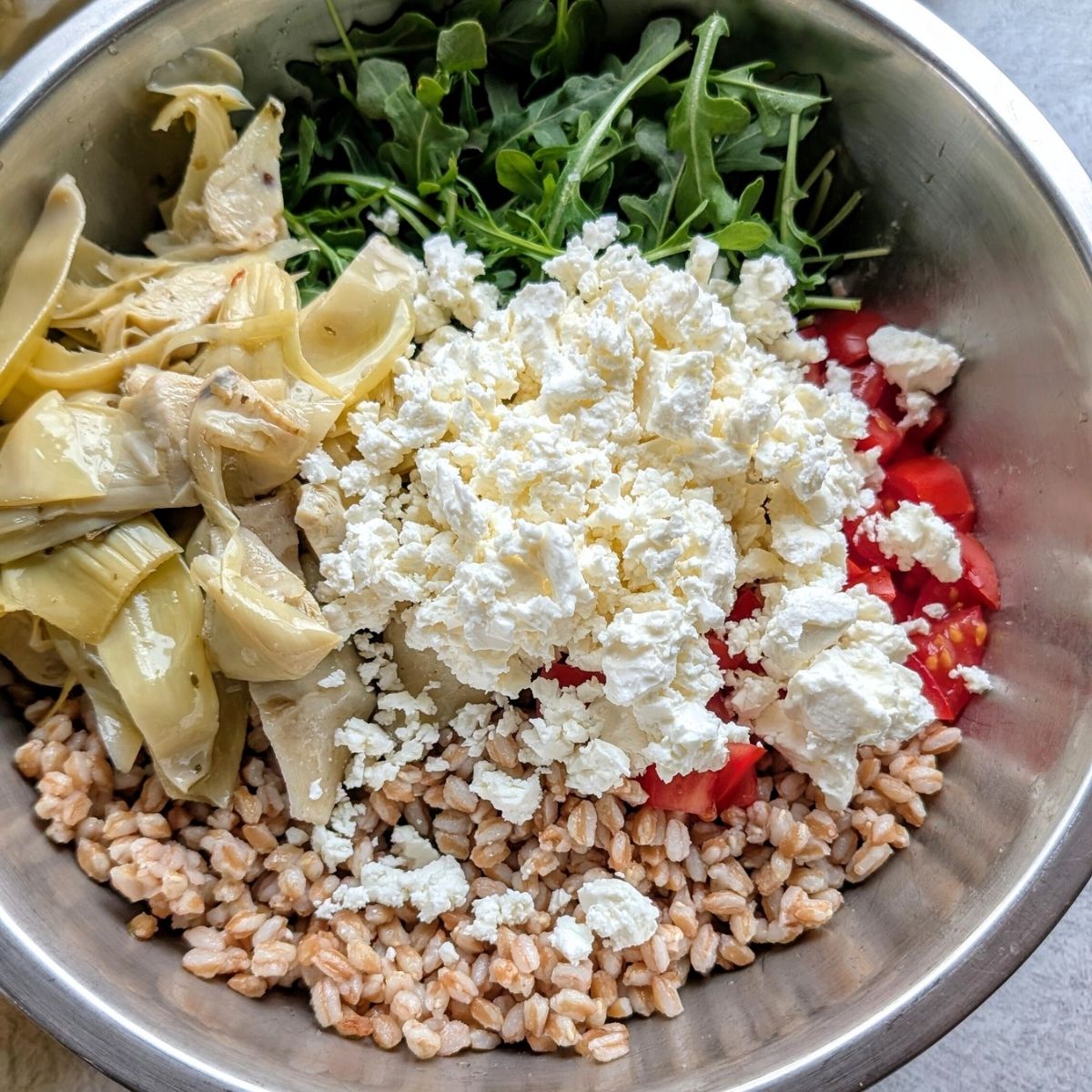 feta cheese and farro salad with fresh greens and tomatoes