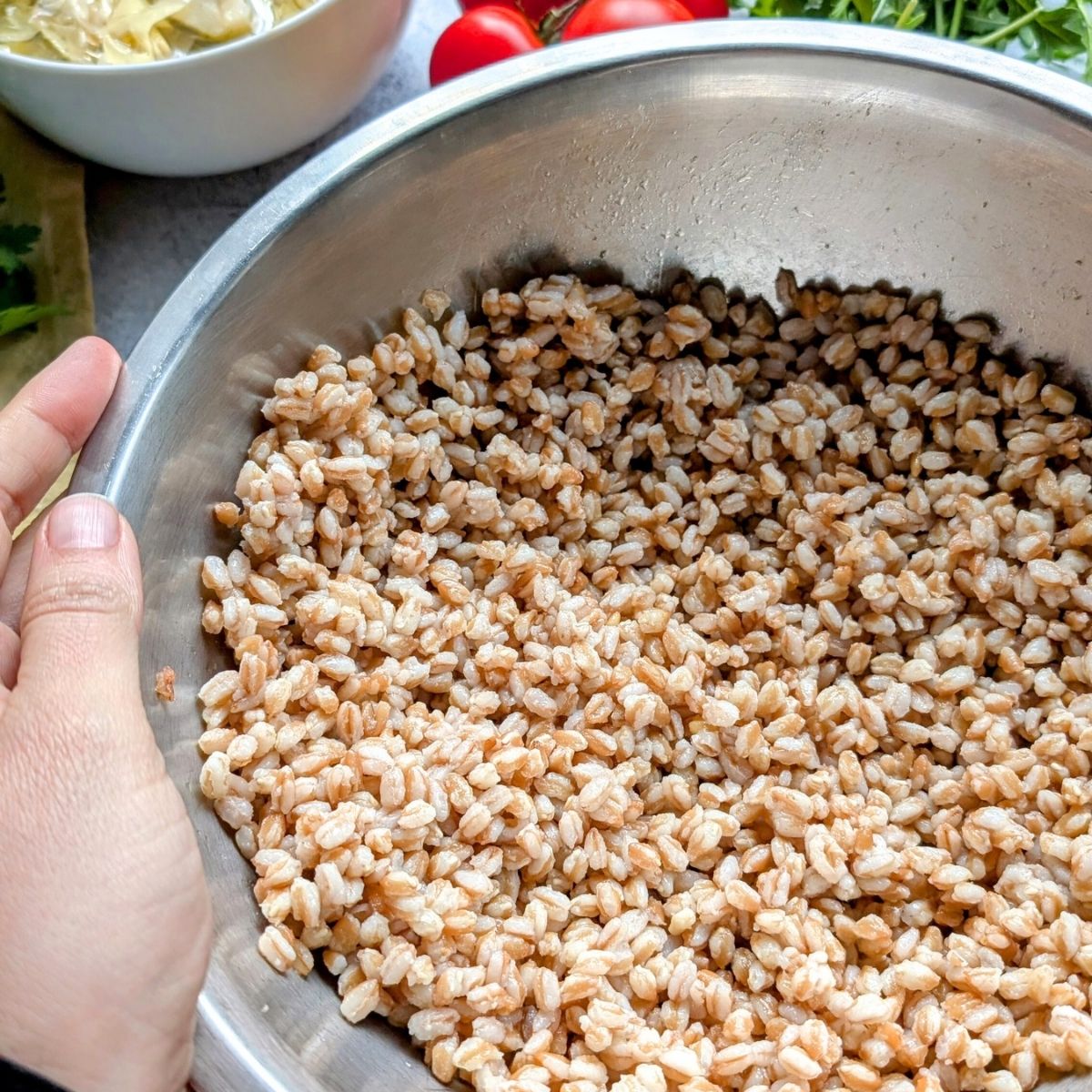 cooked farro in a bowl ready to make a grain salad 