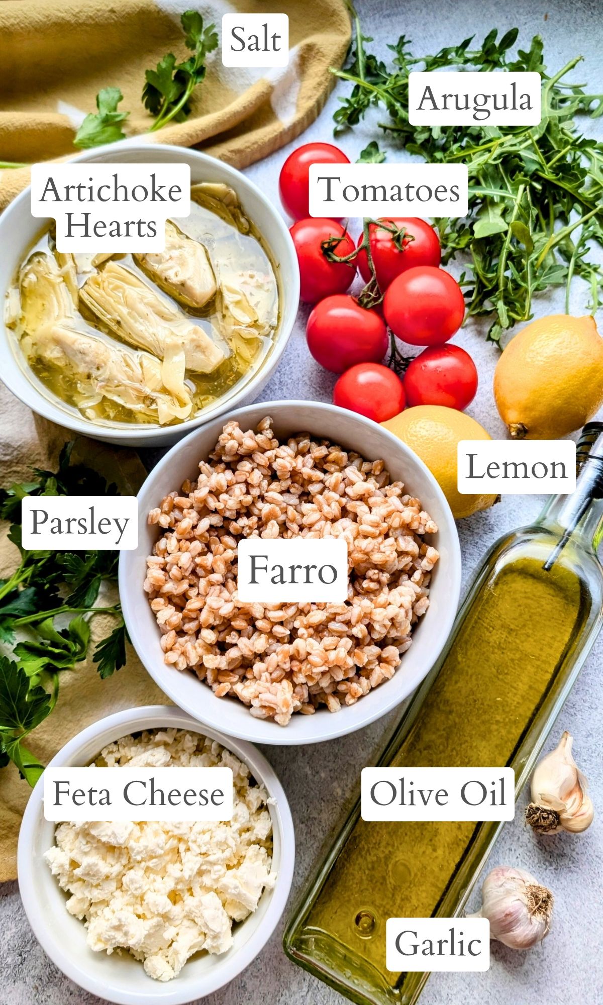 ingredients for farro and artichoke salad with tomatoes lemons arugula and artichoke hearts