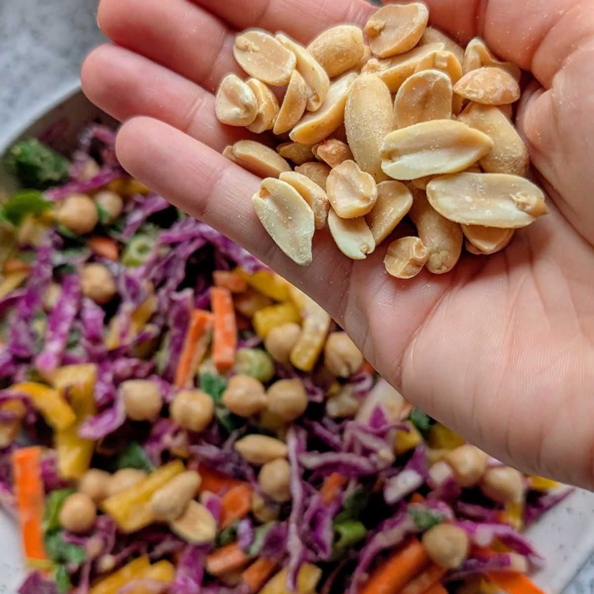 vegan thai chickpea salad with peanuts and crunchy vegetables and fresh roasted peanuts.