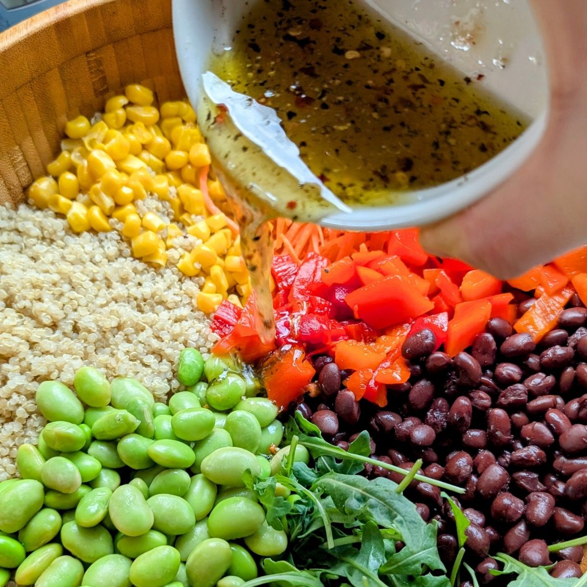 lemon vinaigrette poured oven high protein vegan quinoa salad