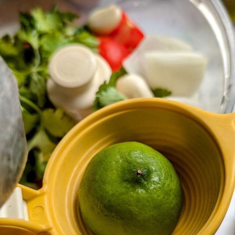 fresh lime being added to garlic scape salsa