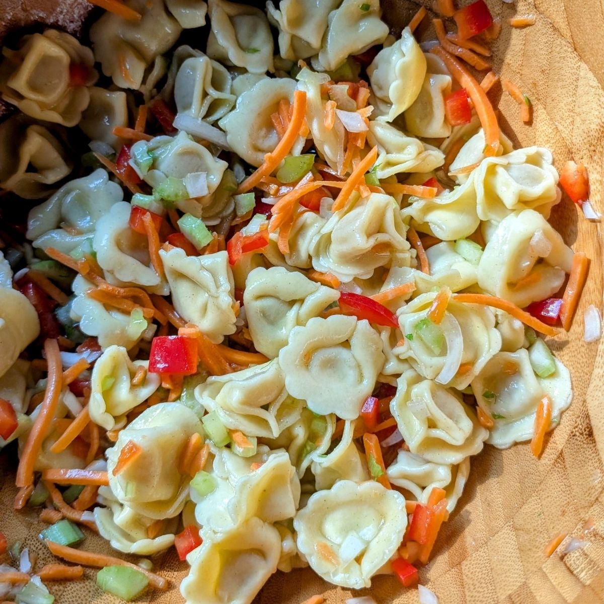 marinated tortellini salad with vegetables in a bowl