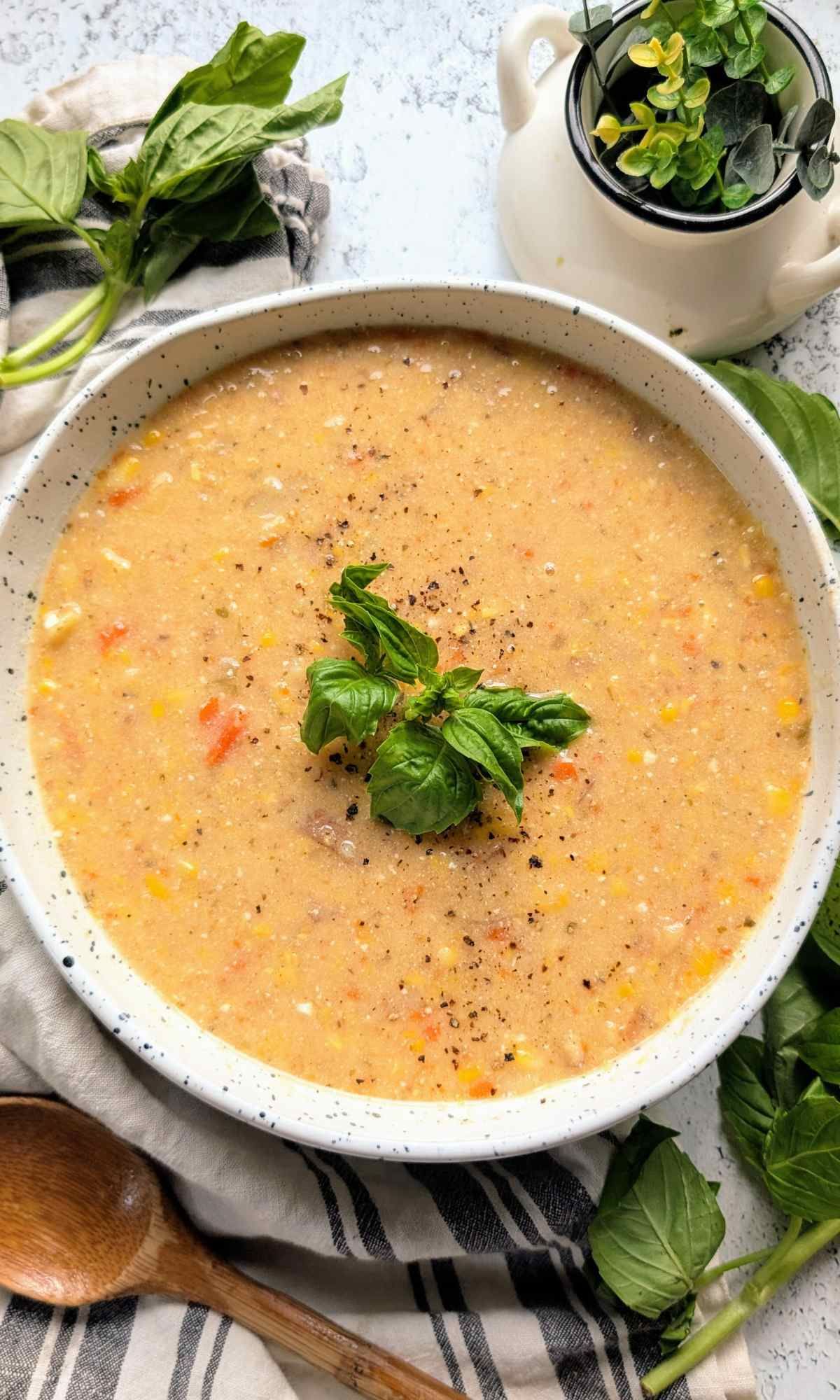 a bowl of dairy free corn soup with cashew cream and fresh basil