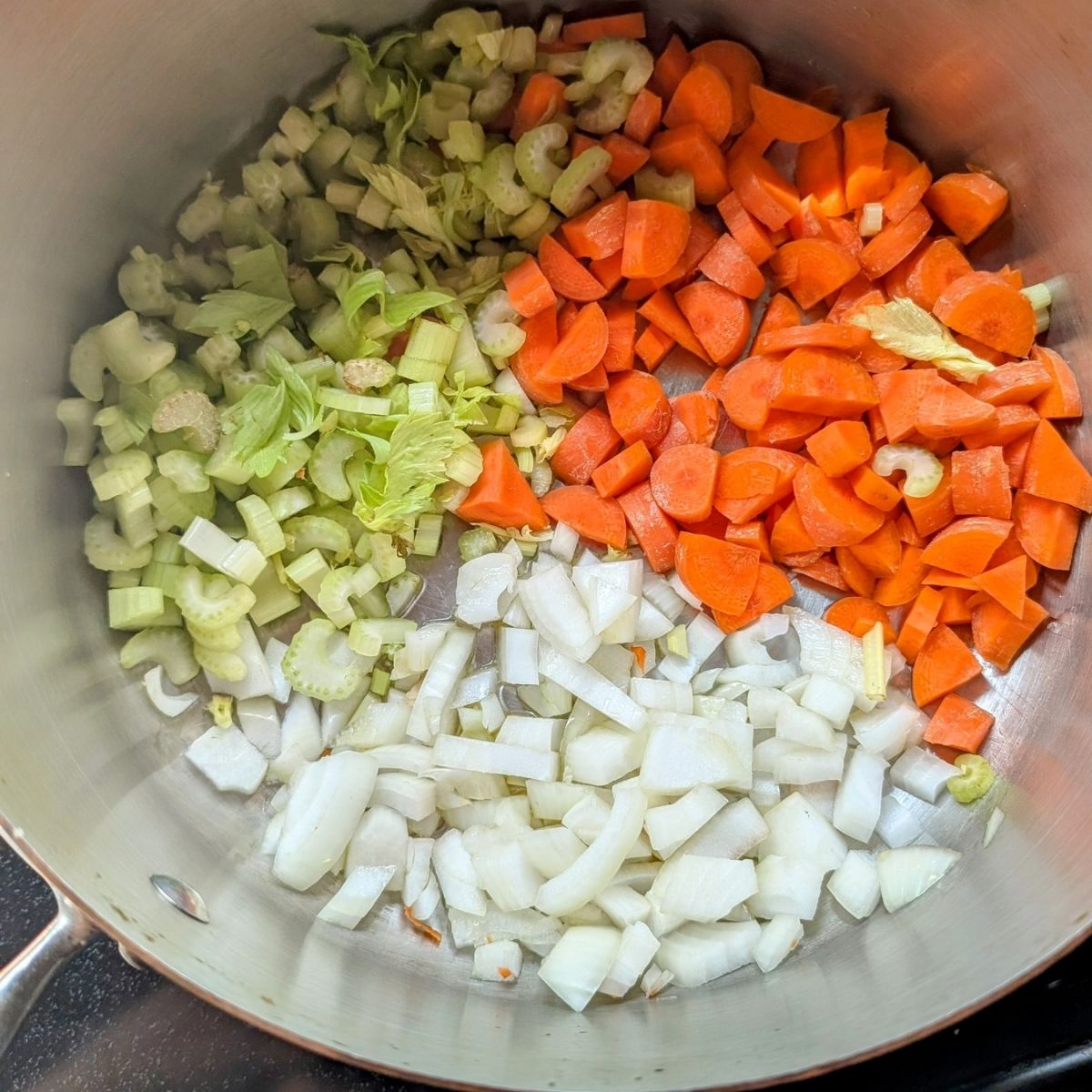 a pot with carrots, celery, and onions to make one pot vegetable cheese tortellini soup