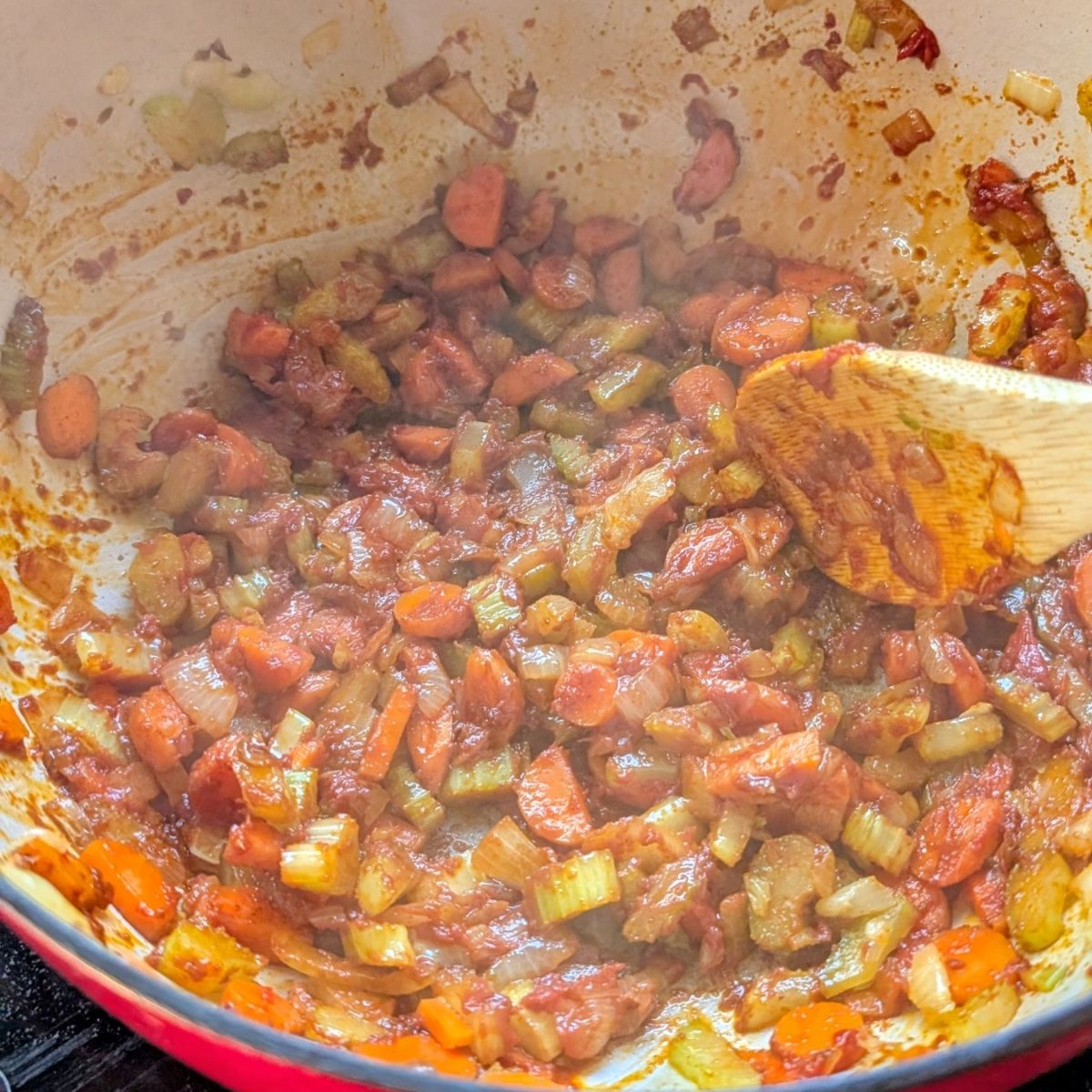carrots, onions, and celery with tomato paste for fasolatha soup with olive oil