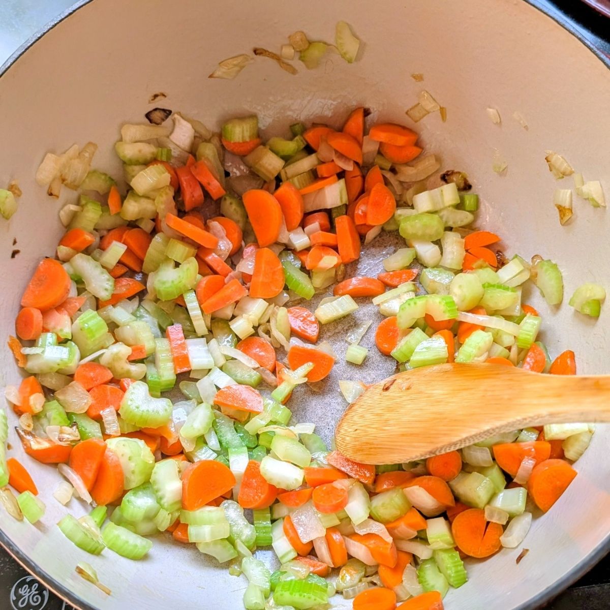 a pot full of onion, carrots, celery, and olive oil for fasolatha soup