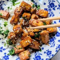 crispy honey tofu recipe with chopsticks in a asian bowl over white rice