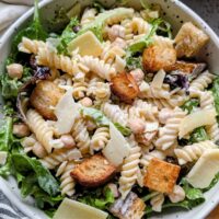 vegetarian caesar pasta salad with noodles, canned chickpeas, and croutons and parmesan cheese