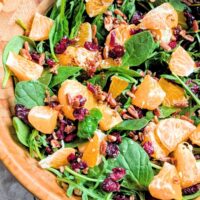 spinach and orange salad with dried fruit and nuts and homemade dressing
